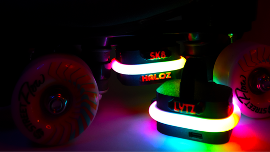 Image of neogleamz SK8Lytz HALOZ Roller Skate Lights on Black Roller Skates in a dark setting