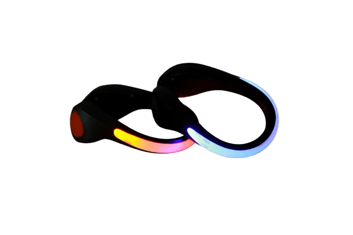 Pair of black clip-on LED shoe lights glowing red-orange and blue, shown on a white background