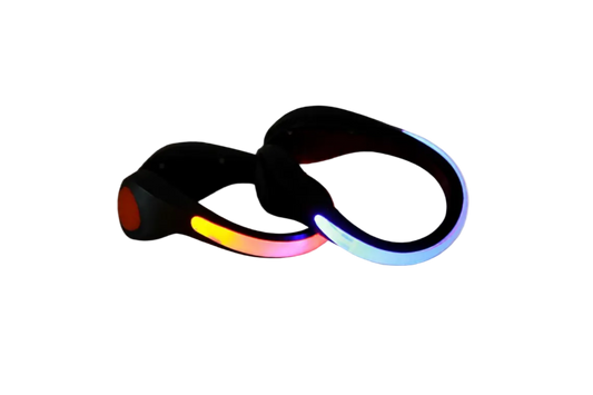 Pair of black clip-on LED shoe lights glowing red-orange and blue, shown on a white background