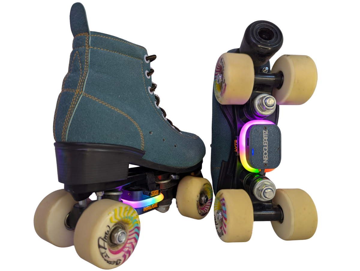 Pair of SK8Lytz HALOZ heel-mounted LED units, dark gray with orange lettering, white light ring and USB-C port