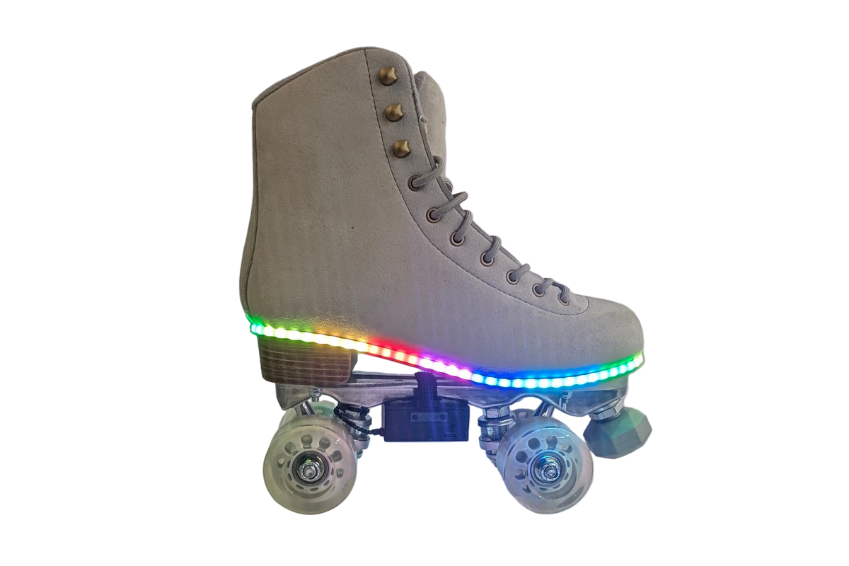 Gray suede roller skate with a rainbow LED strip along the sole and a controller box under the boot, side view